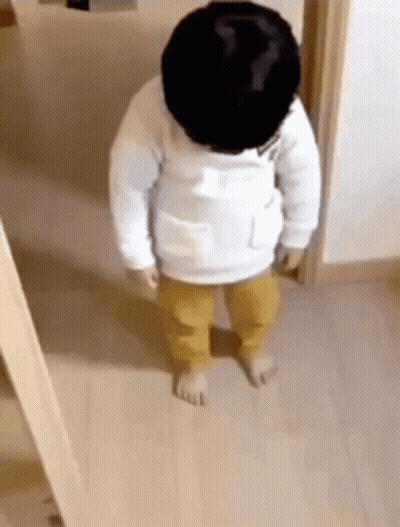 Baby Standing In Wooden Hallway GIF