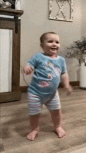 Baby Standing On Wooden Floor GIF