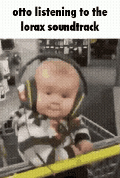 Baby Wearing Headphones In Shopping Cart GIF