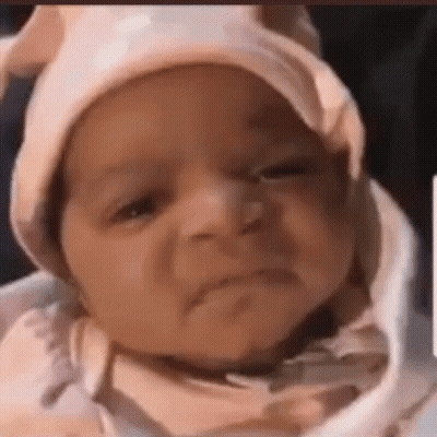 Baby Wearing Pink Hat Making Funny Face GIF