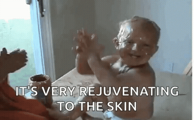 Baby With Chocolate Face Giving High Five GIF