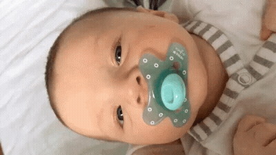 Baby With Pacifier Looking At Camera GIF
