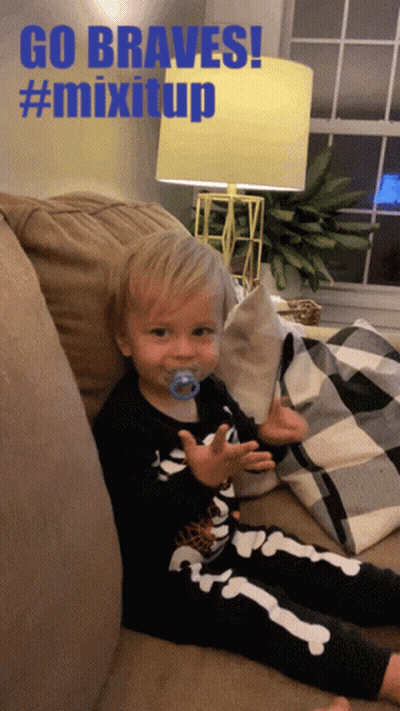 Baby With Pacifier Sitting On Couch Saying Go Braves GIF