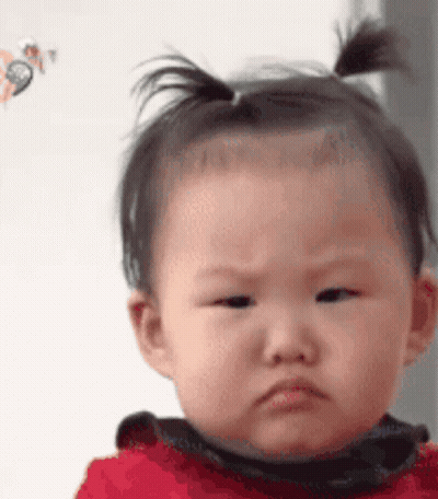 Baby With Ponytail Making Funny Face GIF