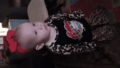 Baby With Red Bow And Leopard Outfit GIF