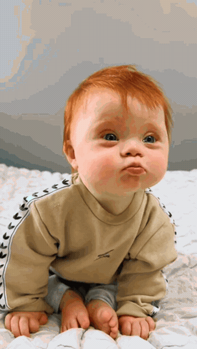 Baby With Red Hair Making Funny Face GIF