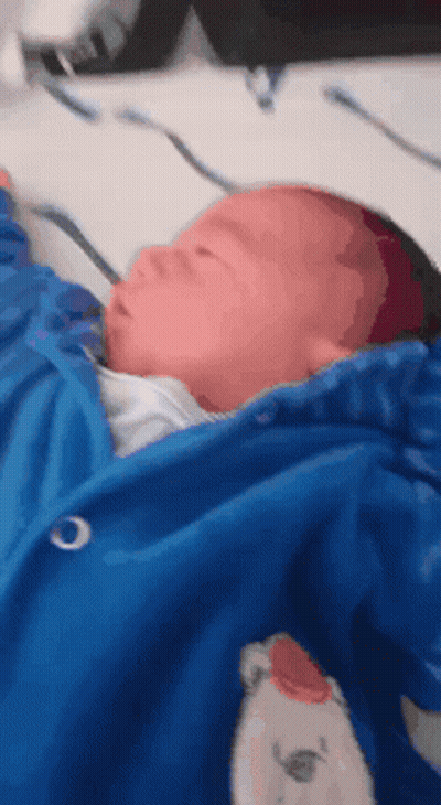 Baby Wrapped In Blue Blanket With Teddy Bear GIF