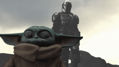 Baby Yoda In Front Of Armored Man Arms Crossed GIF