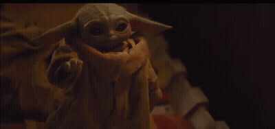 Baby Yoda Looking At Camera On Bed GIF