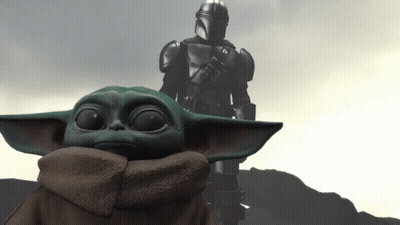 Baby Yoda Sitting In Front Of Statue GIF