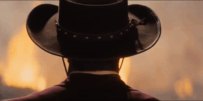 Back Of Man In Cowboy Hat Watching Fire GIF