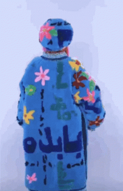 Back Of Person In Blue Coat With Flowers And Letters GIF
