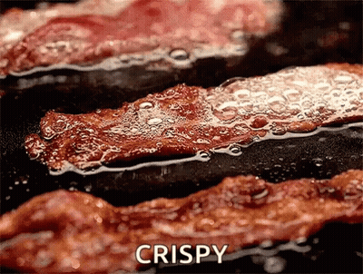 Bacon Cooking In Frying Pan With Word Crispy GIF