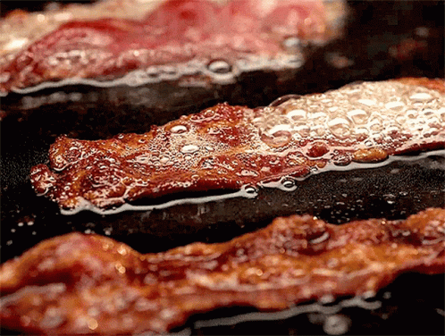 Bacon Is Being Cooked In A Frying Pan GIF