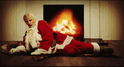 Bad Santa On The Fireplace GIF