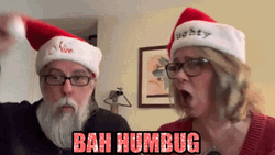 Bah Humbug Matured Couple Wearing Santa Hats GIF