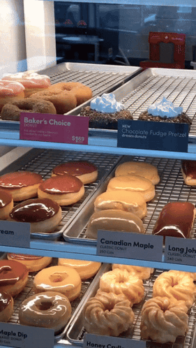Baker 'S Choice Donuts Are Displayed On A Shelf GIF