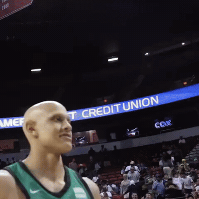 Bald Basketball Player In Front Of Credit Union Banner GIF