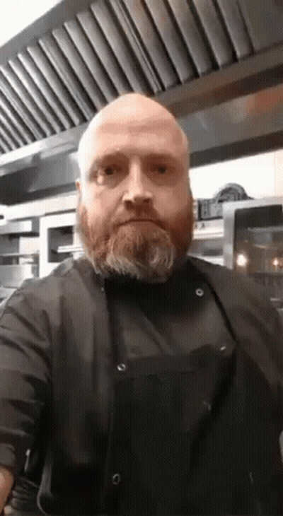 Bald Bearded Man In Black Apron And Shirt GIF