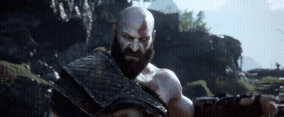 Bald Bearded Man in Field With Mountains
