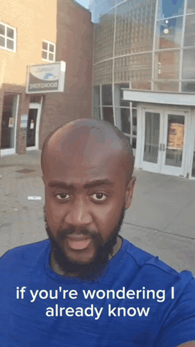 Bald Bearded Man In Front Of Photobook Building GIF