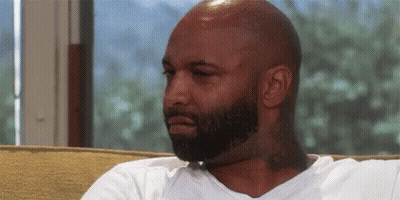 Bald Bearded Man Sitting On Couch GIF