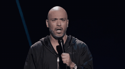 Bald Bearded Man Speaking Into Microphone With Watch GIF