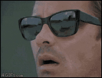 Bald Bearded Man Wearing Sunglasses and Earbuds