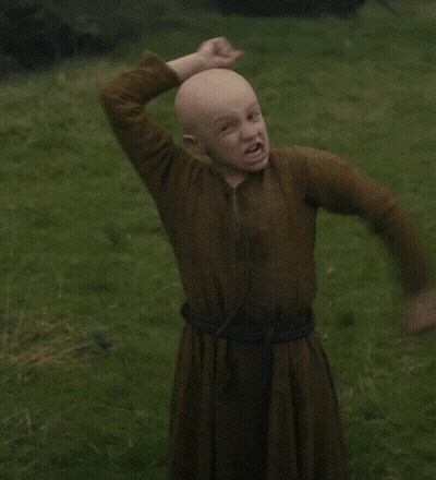 Bald Boy In Brown Dress In Grassy Field GIF