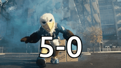 Bald Eagle Mascot Standing Next To Box With 5-0 GIF