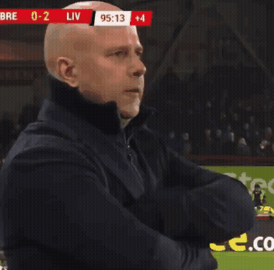 Bald Man Arms Crossed Soccer Field Scoreboard Liv GIF