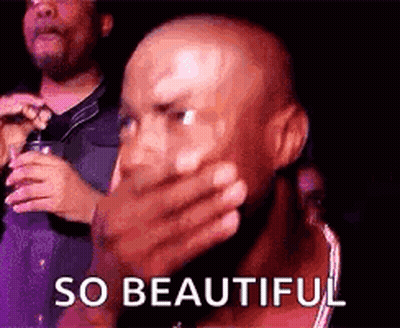 Bald Man Covering Mouth And Man Holding Microphone GIF