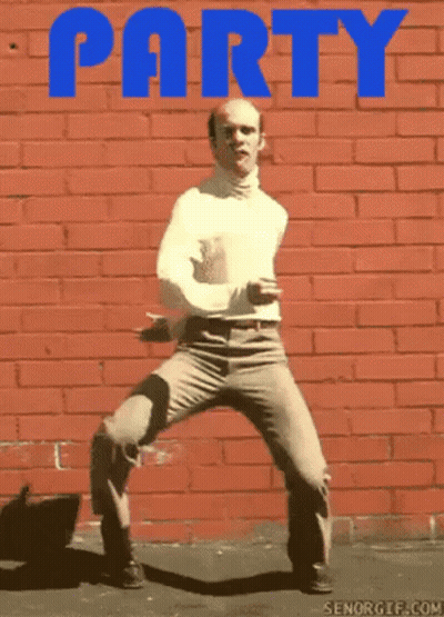 Bald Man Dancing In Front Of Red Brick Wall Saying Party GIF