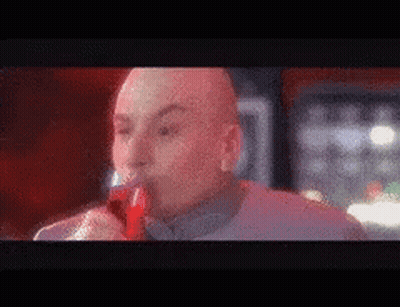 Bald Man Drinking Red Liquid From Bottle GIF