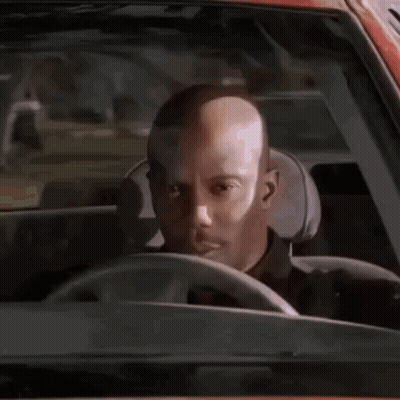 Bald Man Driving Looking At Camera GIF