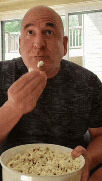 Bald Man Eating Popcorn From Bowl GIF
