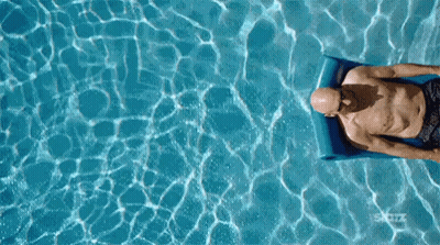 Bald Man Floating On Raft In Pool GIF