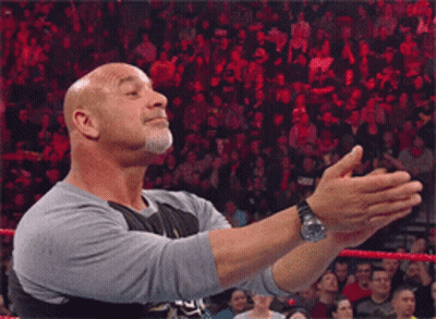 Bald Man Giving Thumbs Up In Front Of Crowd GIF