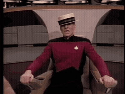 Bald Man Holding Head With Gloved Hands GIF
