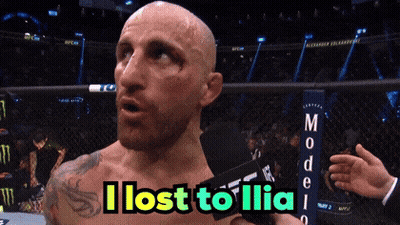 Bald Man Holding Microphone Says I Lost To Ilia GIF