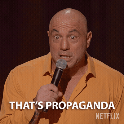 Bald Man Holding Microphone Says That's Propaganda GIF