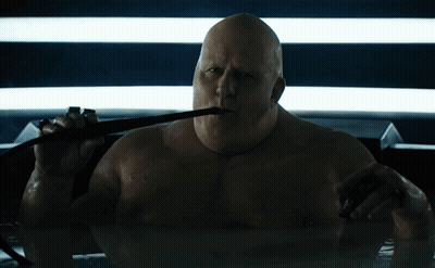Bald Man Holding Whip In Mouth GIF
