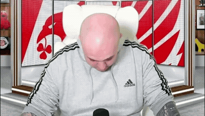 Bald Man In Adidas Shirt In Front Of Sesame Street Sign GIF