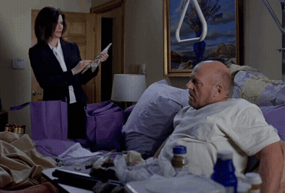 Bald Man In Black Jacket In Front Of House GIF