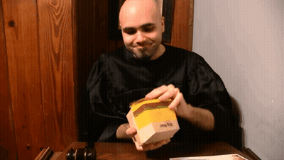 Bald Man In Black Robe Opening Big Mac GIF