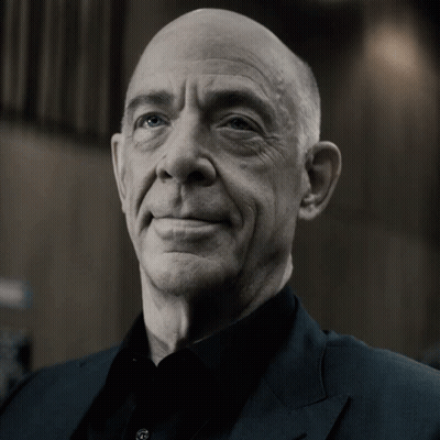 Bald Man In Black Shirt And Suit Smiling GIF