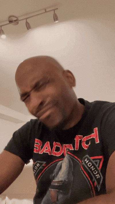 Bald Man In Black Shirt Saying Bad To Honor With Funny Face GIF