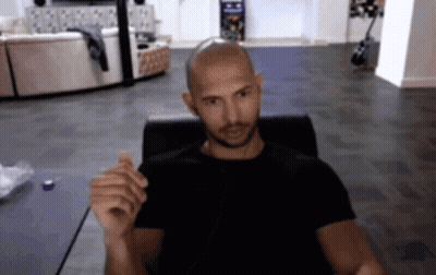Bald Man In Black Shirt Sitting At Computer GIF