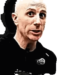 Bald Man In Black Shirt With Badge Sticker