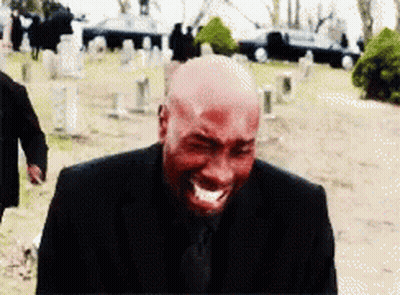 Bald Man In Black Suit Crying In Cemetery GIF